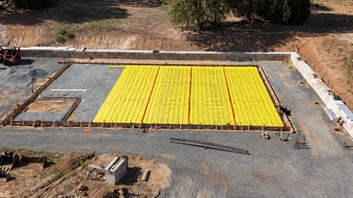 Graded building pad with concrete block retaining wall