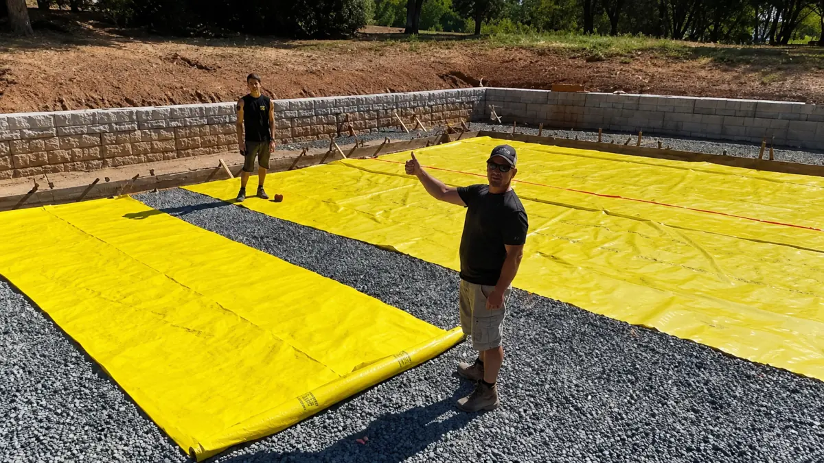 Finishing a graded pad and retaining wall